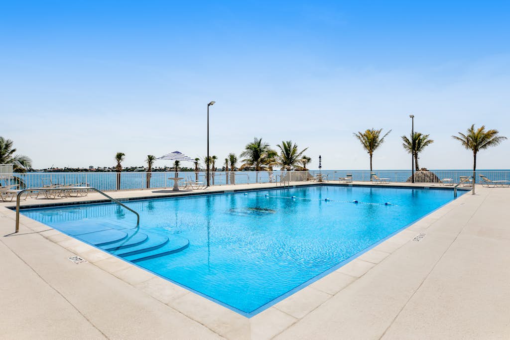 Modern waterfront condo with pool, shared dock, & W/D - snowbird-friendly