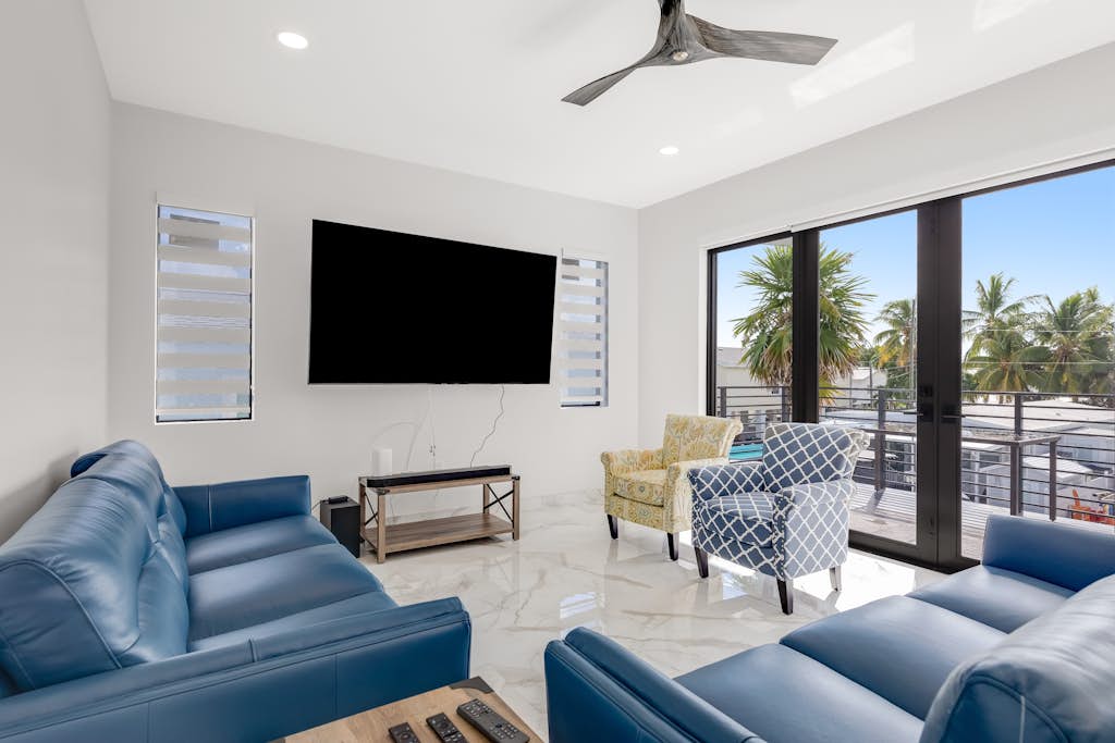 Modern canal-front home with a rooftop deck, open-concept interior, AC,  & W/D