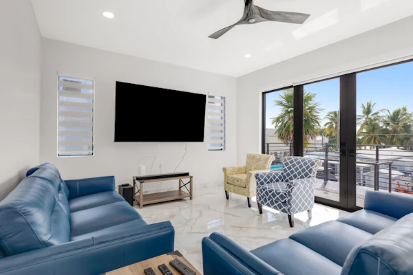 Modern canal-front home with a rooftop deck, open-concept interior, AC, & W/D