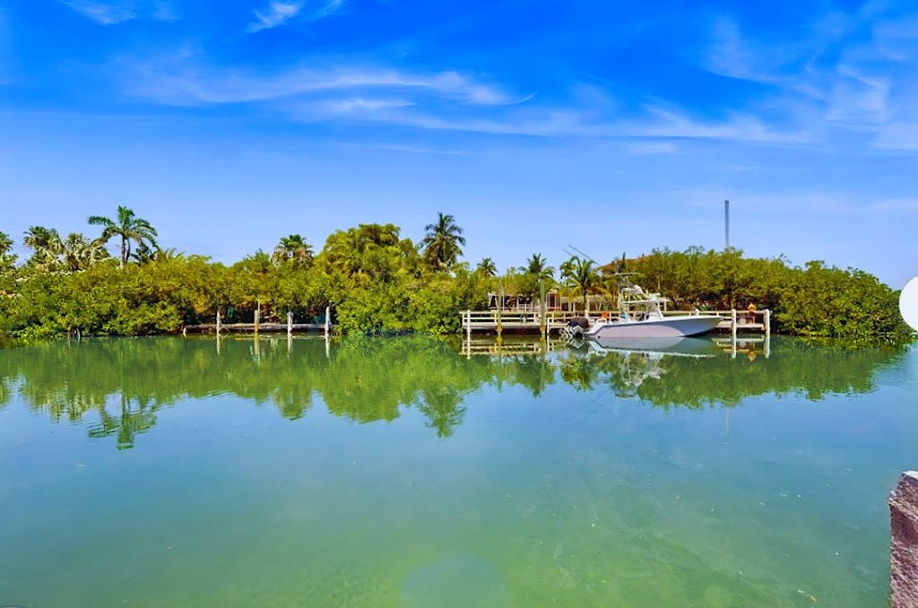 Canal front home w/ a dock, private pool, spacious deck, & easy water access