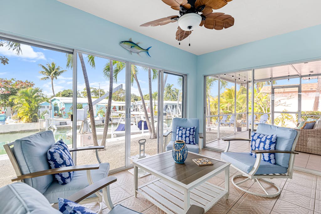 Single-level waterfront home with furnished Florida room, dock, washer/dryer