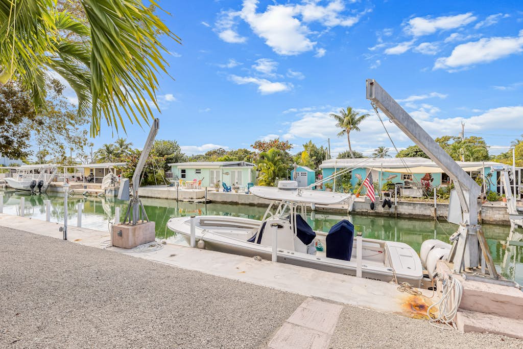 Single-level waterfront home with furnished Florida room, dock, washer/dryer