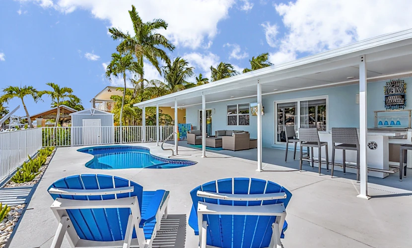Waterfront home with private heated pool, dock, canal views, grill, pool spa, AC