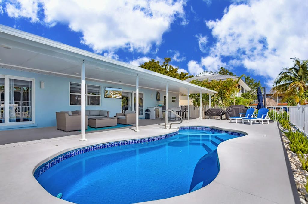 Waterfront home with private heated pool, dock, canal views, grill, pool spa, AC