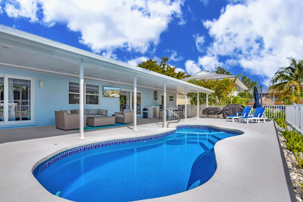Waterfront home with private heated pool, dock, canal views, grill, pool spa, AC