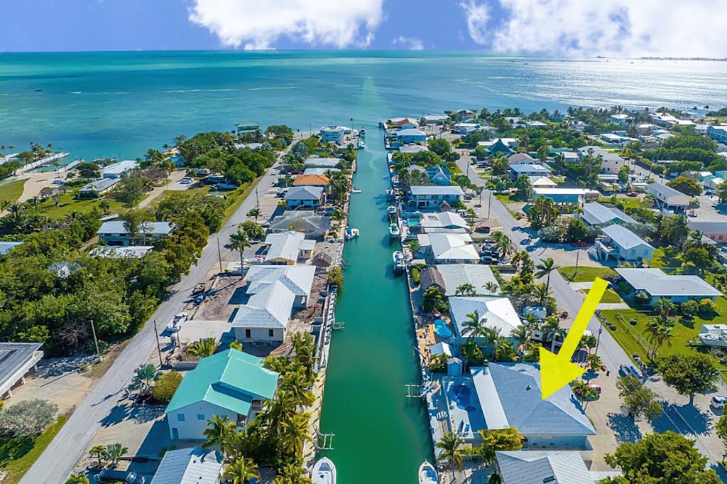 Waterfront home with private heated pool, dock, canal views, grill, pool spa, AC