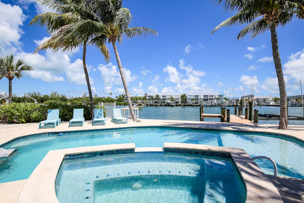 Waterfront home with Cabana Club access, private pool, spa, & dock