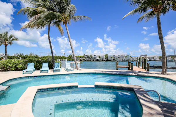 Waterfront home with Cabana Club access, private pool, spa, & dock