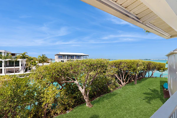 Charming townhome with ocean views, an open porch & steps from the water