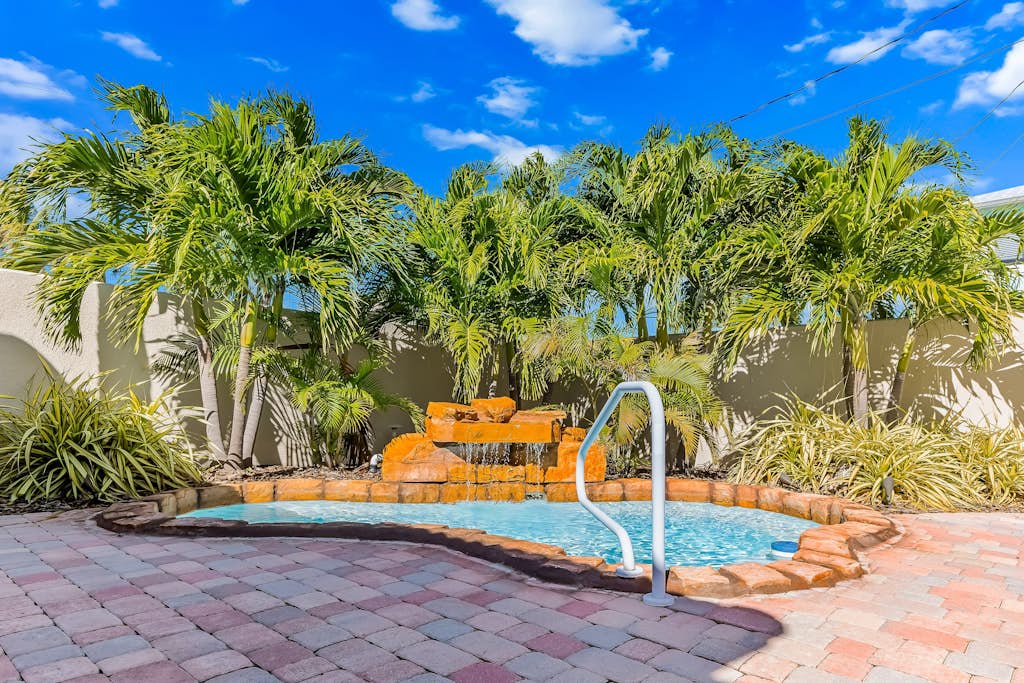 Custom canal-front home with private pool, palapa hut, & outdoor kitchen