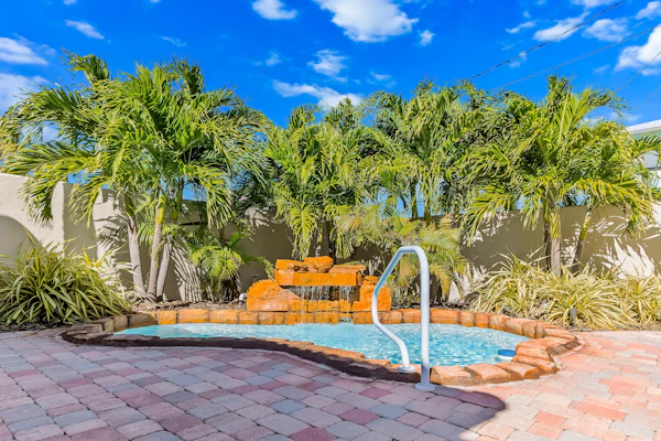 Custom canal-front home with private pool, palapa hut, & outdoor kitchen