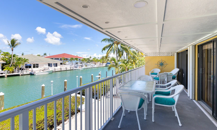 Waterfront duplex with hot tub, pool, & beach access - W/D, balcony, and grill