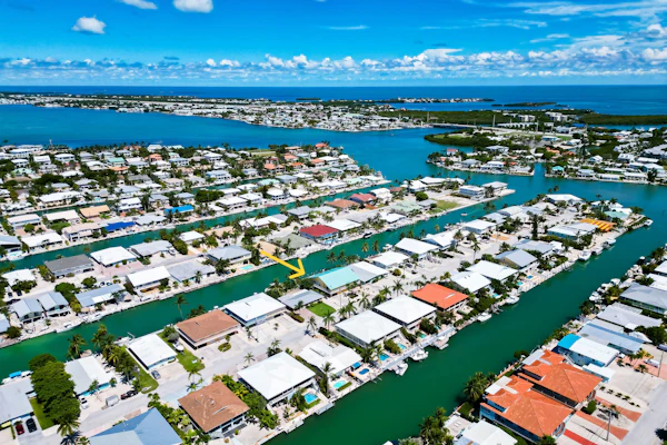 Waterfront duplex with hot tub, pool, & beach access - W/D, balcony, and grill