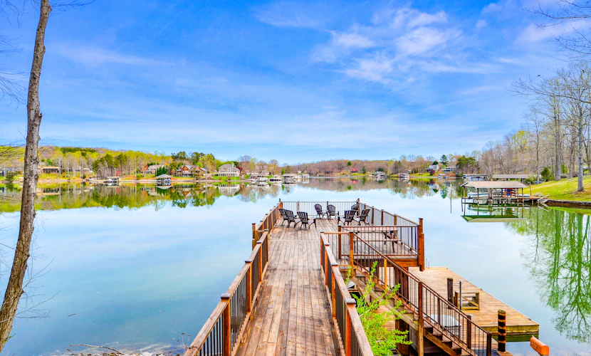 Waterfront lake-view home with dock, fireplace, pool table, kayaks, & firepit