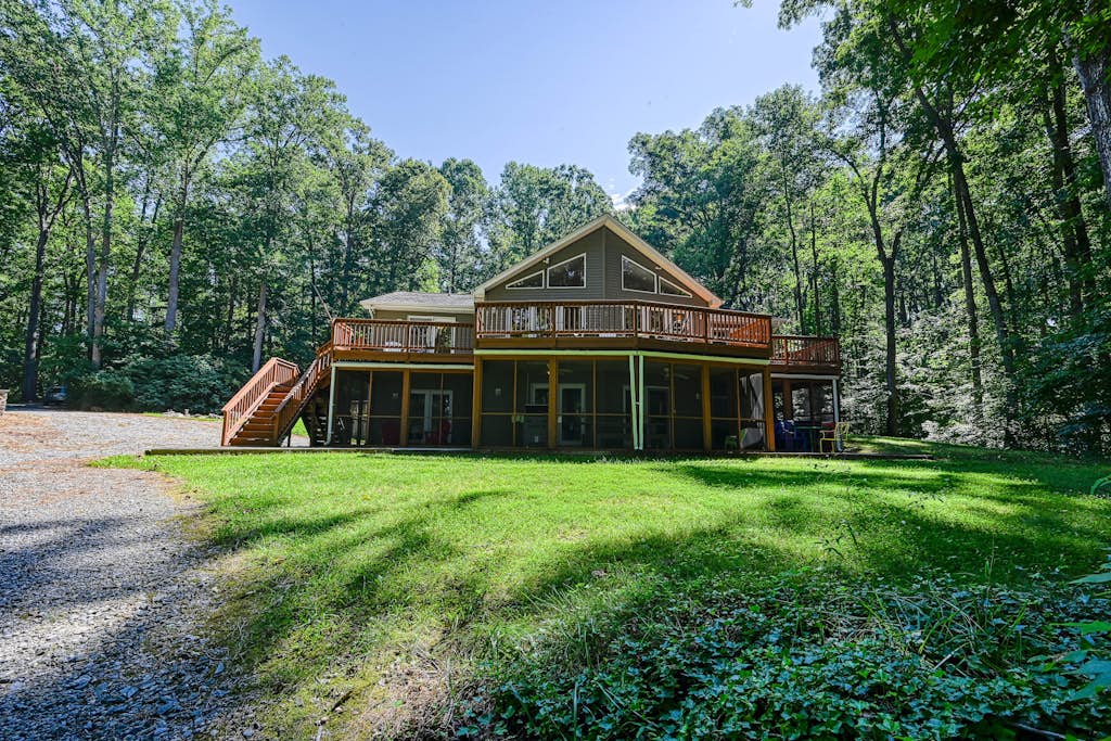 Lakefront home with deck, hot tub, game room, kayaks, & fireplace