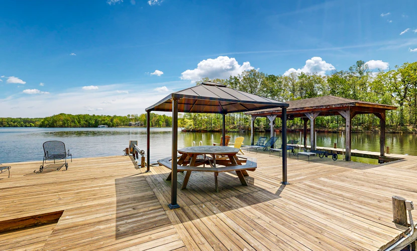 Lakefront home with two kitchens, a dock, firepit, & pontoon