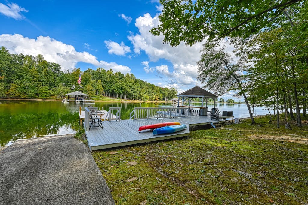 Stunning lakeside home with dock, large deck, kayaks, firepit, & pool table