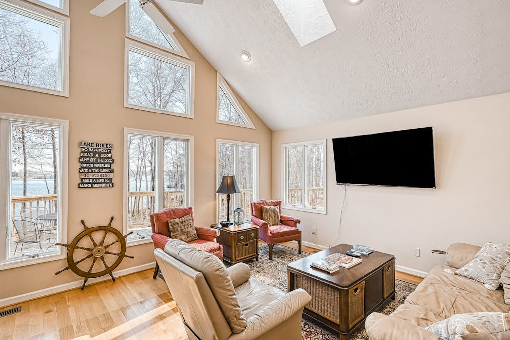 Stunning lakeside home with dock, large deck, kayaks, firepit, & pool table