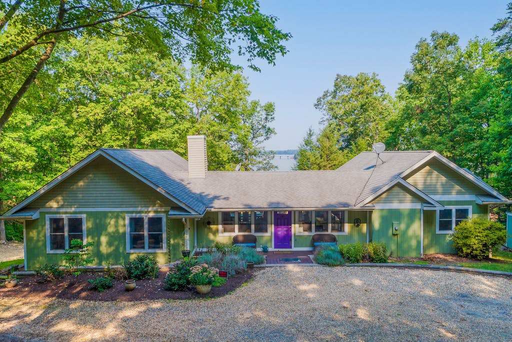 Lakefront home with granite counters, fireplace, lake views, & dock