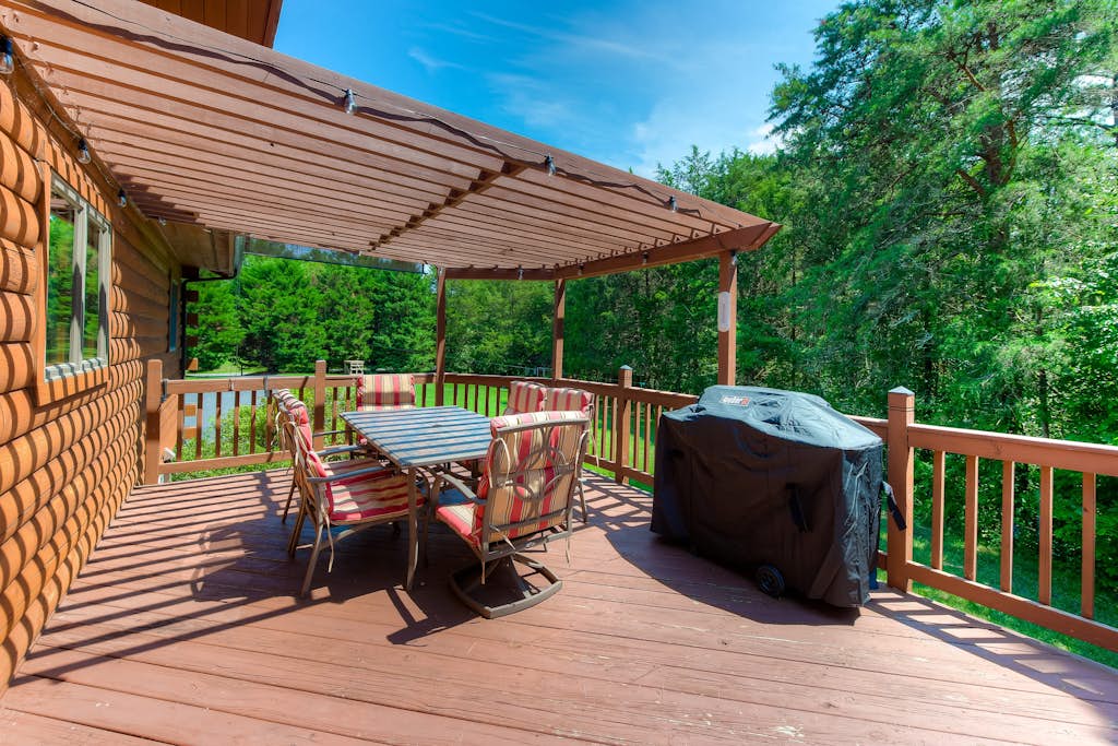 Three-story dog-friendly home with large deck, wood swing, firepit, lawn, & more