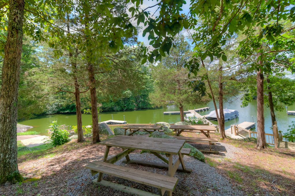 Three-story dog-friendly home with large deck, wood swing, firepit, lawn, & more