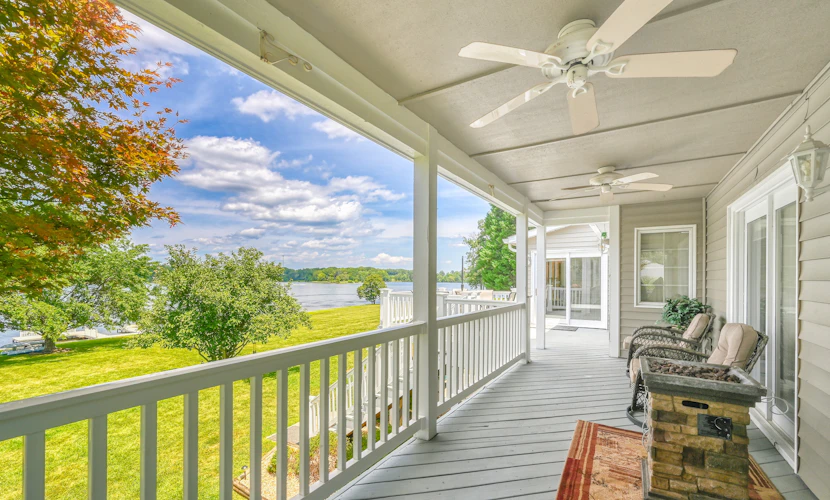 Lakefront retreat with a large yard, stone fire pit, gazebo, deck, & dock