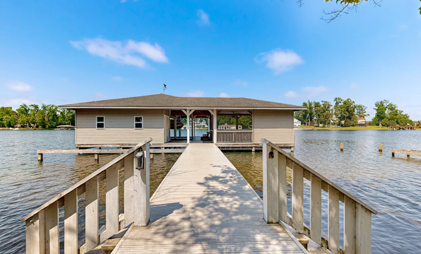 Relaxing lakeside retreat with boathouse, dock, deck, firepit and screened porch