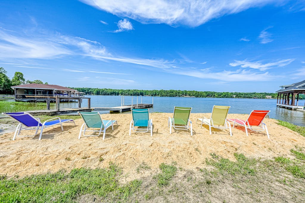 Dog-friendly lakefront home with a game room, children's items, and firepit