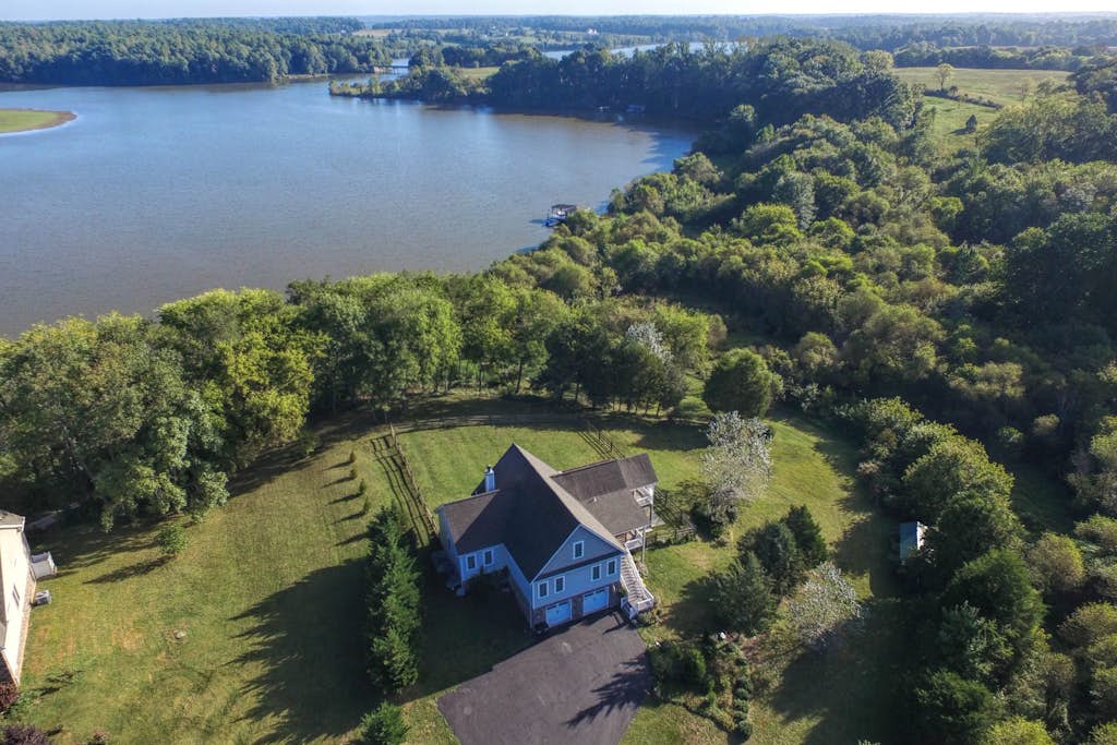 Nature lover’s lakefront home with a beach, dock, fire ring, & more