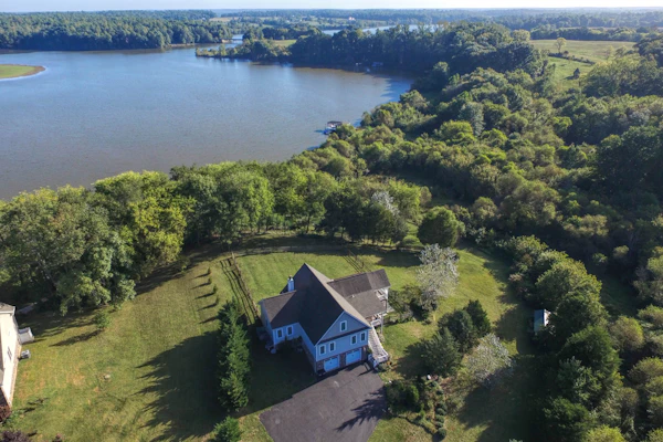 Nature lover’s lakefront home with a beach, dock, fire ring, & more