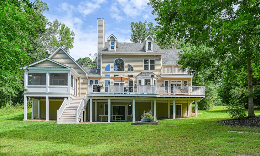 Lakefront home with private beach, dock, deck, kayaks, game room, & fireplace