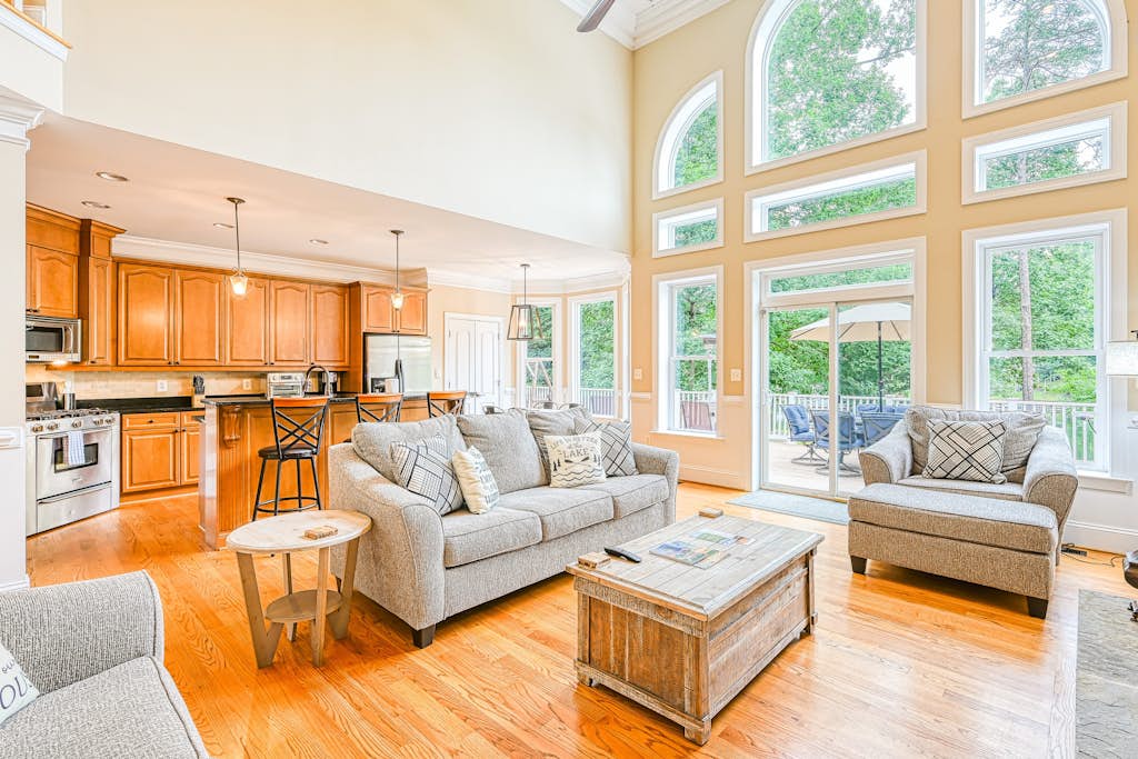 Lakefront home with private beach, dock, deck, kayaks, game room, & fireplace