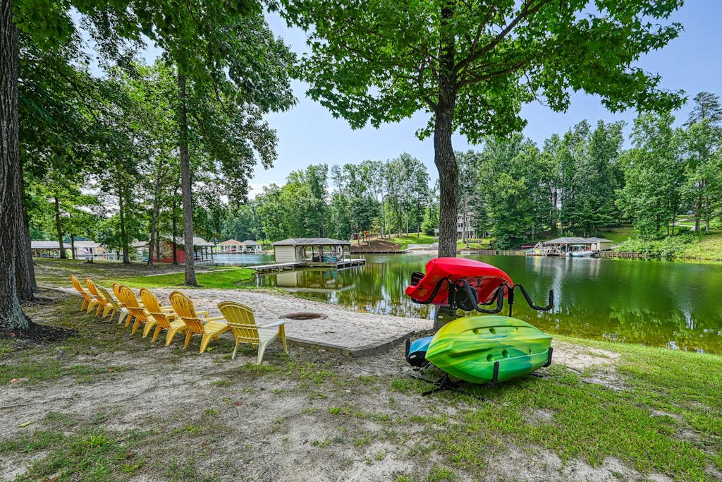 Lakefront home with private beach, dock, deck, kayaks, game room, & fireplace
