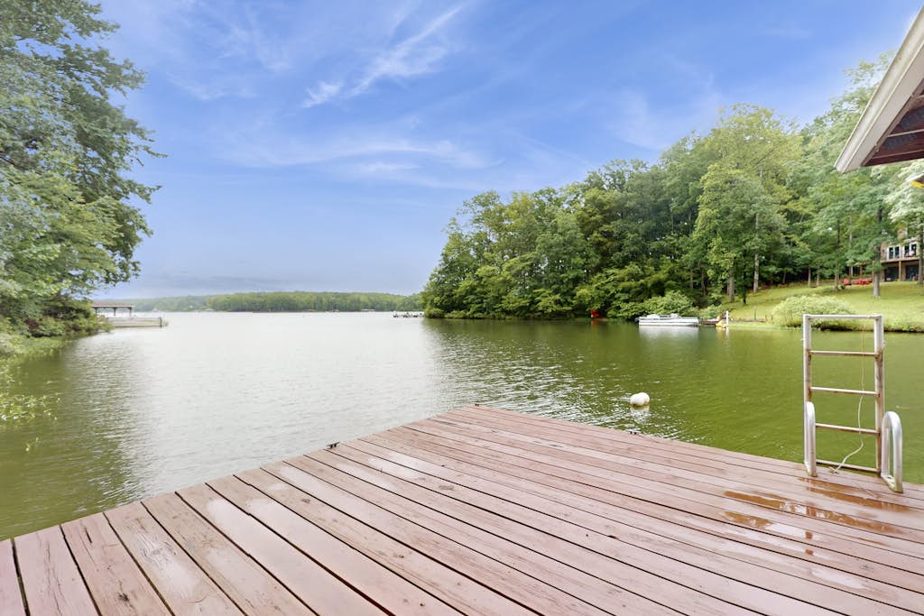 Spacious waterfront escape with screened porch, water slide, kayak, & games