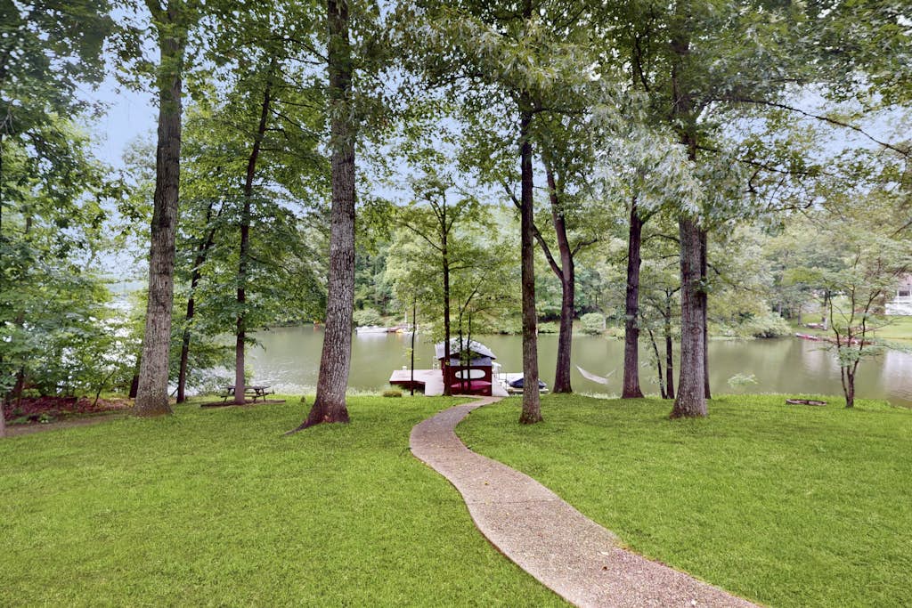 Spacious waterfront escape with screened porch, water slide, kayak, & games