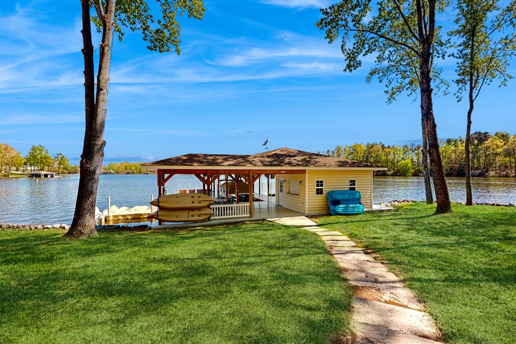 Lakefront home with private dock, kayaks, beach, badminton, firepit, & deck