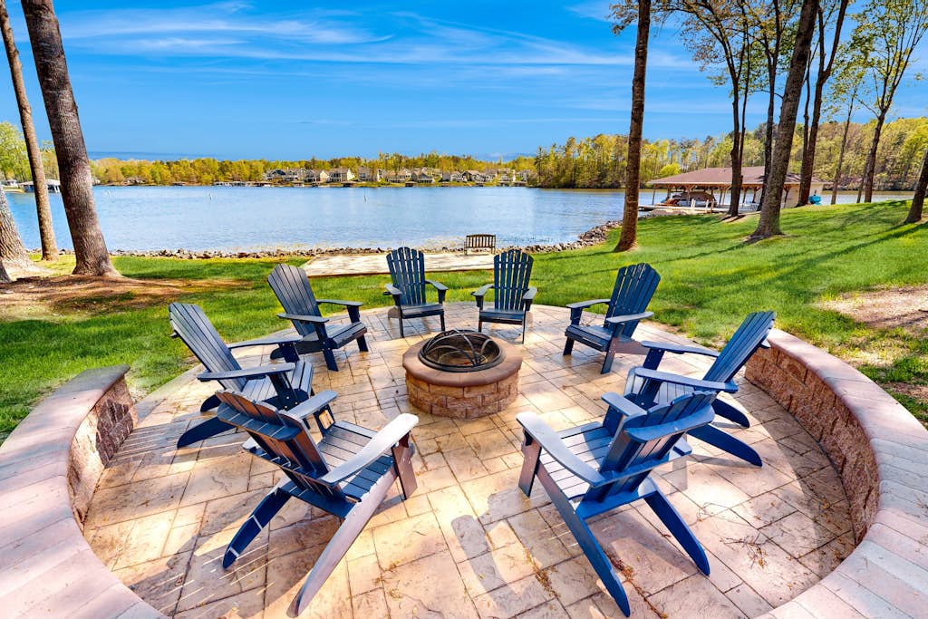 Lakefront home with private dock, kayaks, beach, badminton, firepit, & deck