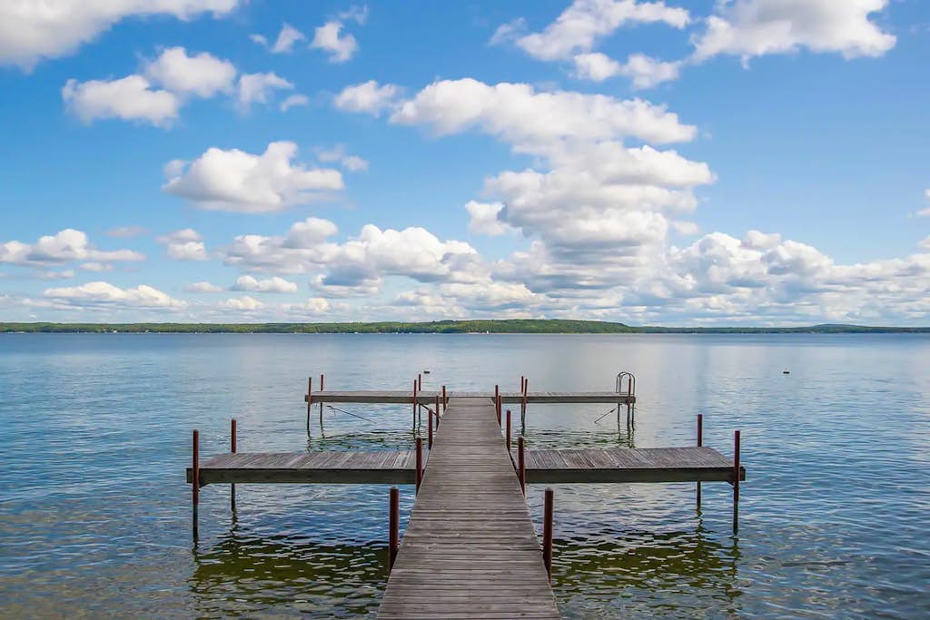 Charming lakefront cottage with large yard, dock, & fire pit - close to downtown
