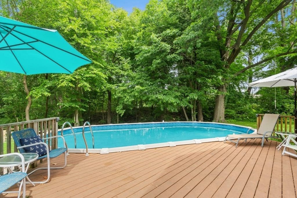 Charming cottage with fast WiFi, fire pit, above-ground pool, & huge sunroom
