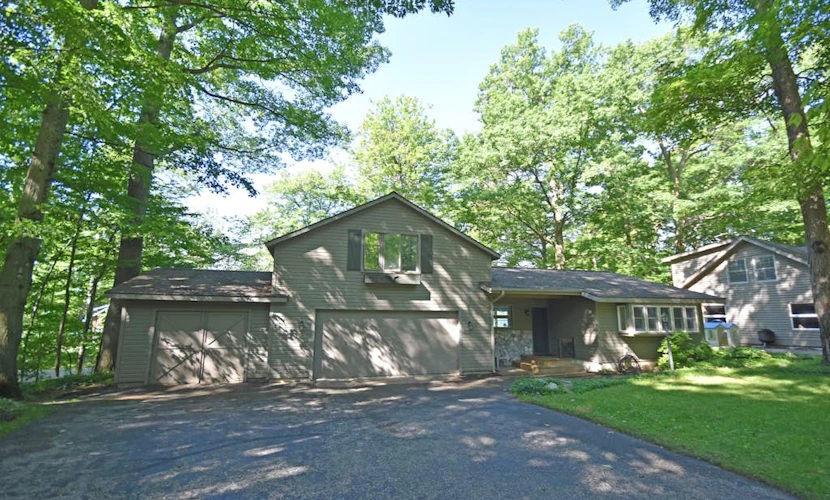 Lakefront home on Little Glen Lake with fireplace, deck, gas grill, and firepit