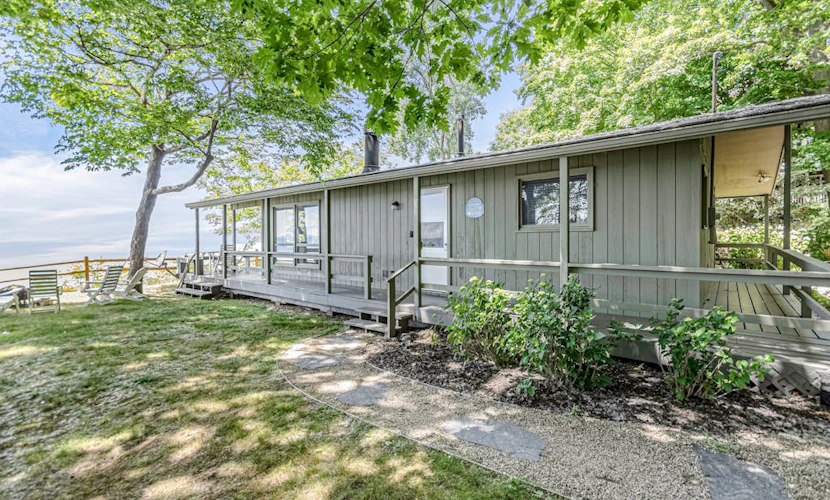 Quaint lakefront cottage w/ private hot tub, firepit, & beautiful sunset views