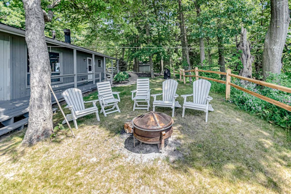 Quaint lakefront cottage w/ private hot tub, firepit, & beautiful sunset views