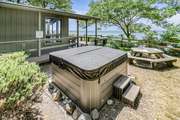 Quaint lakefront cottage w/ private hot tub, firepit, & beautiful sunset views