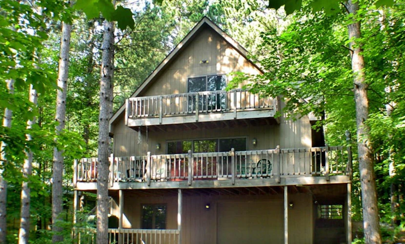 Stunning two-story home in the trees w/ a firepit, furnished deck, & balcony