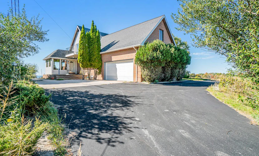 Dog-friendly, lake view home with three season room, fireplace, video projector