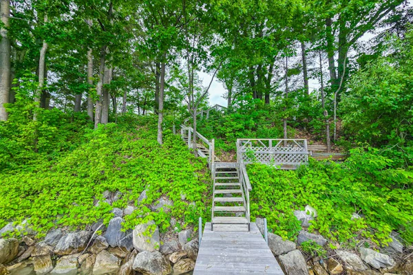 Charming lakefront cottage with large yard, dock, & fire pit - close to downtown