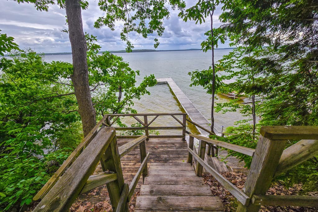 Incredible lakefront retreat with dock, fire pit, decks, yard, & amazing views
