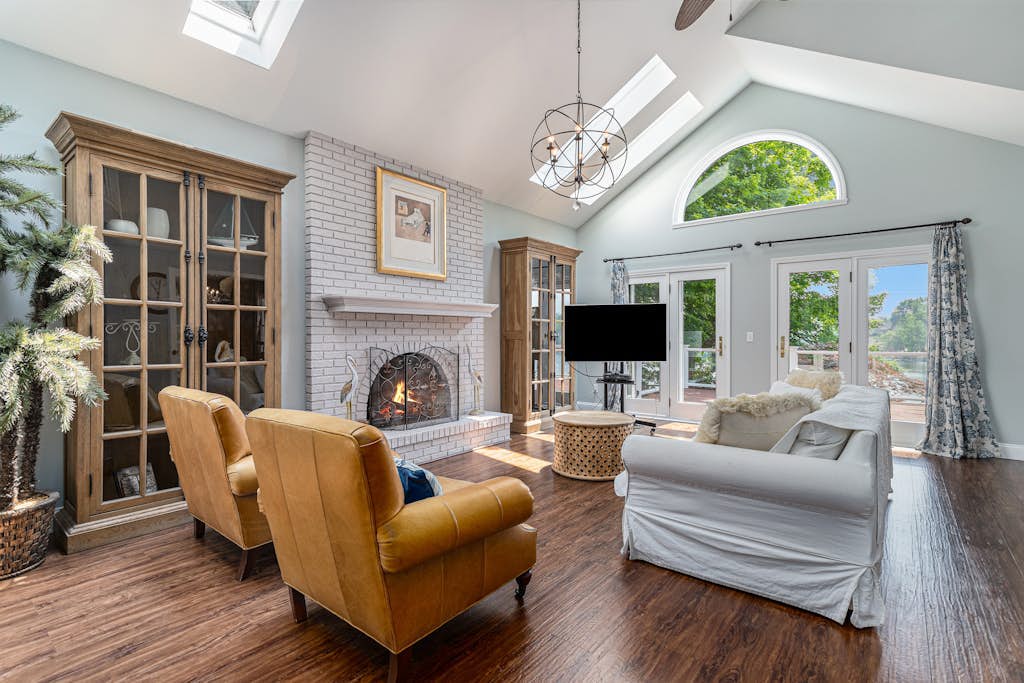 Serene lakefront retreat with an expansive deck, dock access, game room, & AC