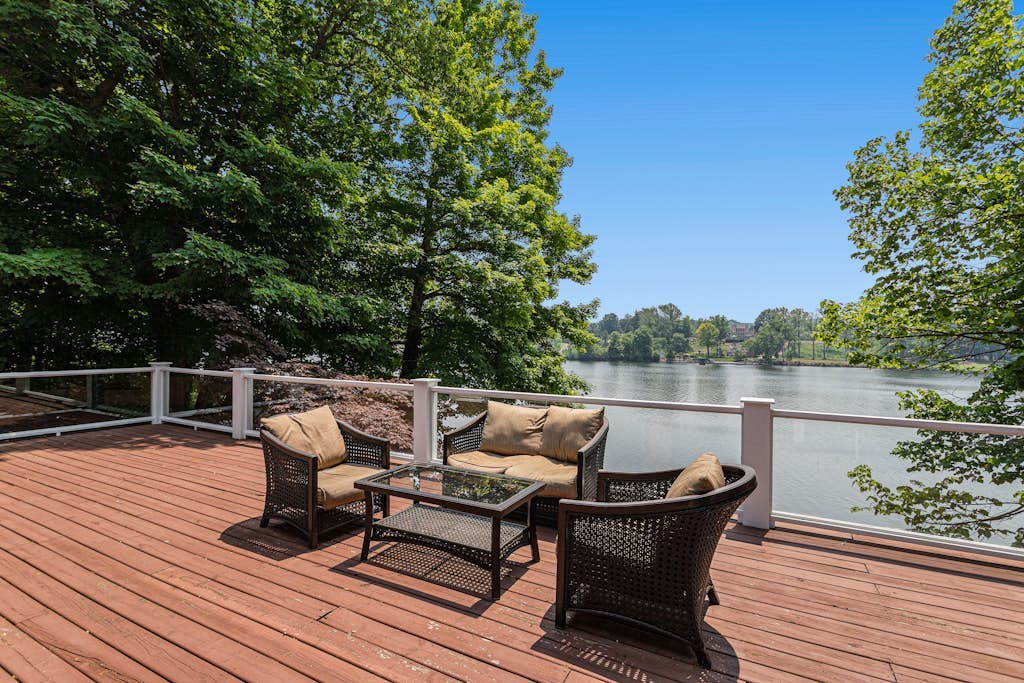 Serene lakefront retreat with an expansive deck, dock access, game room, & AC