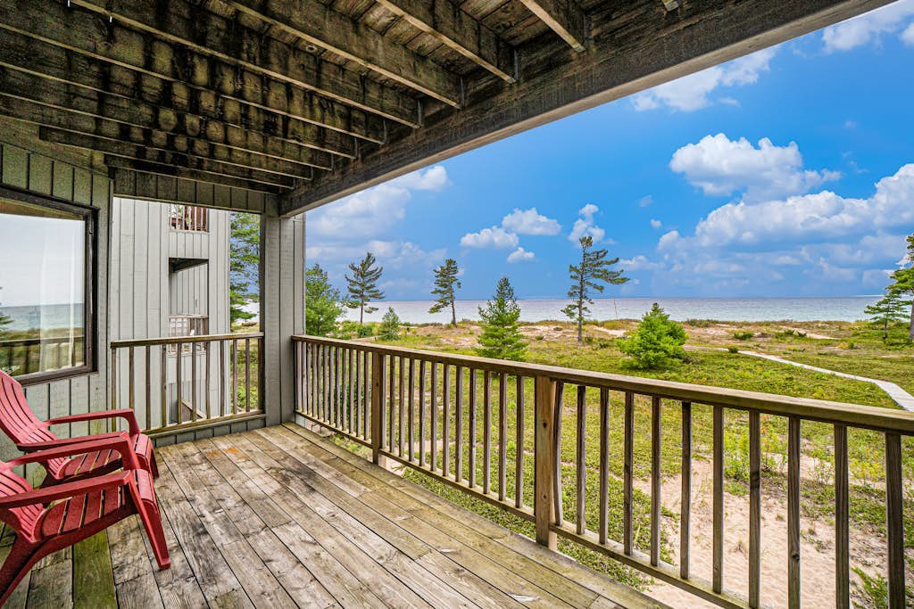 Lake-view condo with private beach, fireplace, deck, washer/dryer, streaming